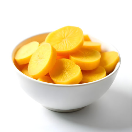 Bowl of sliced persimmon on white background, closeupの素材