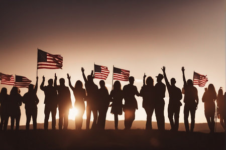 Silhouettes of people holding the American flag on the sunset backgroundの写真素材