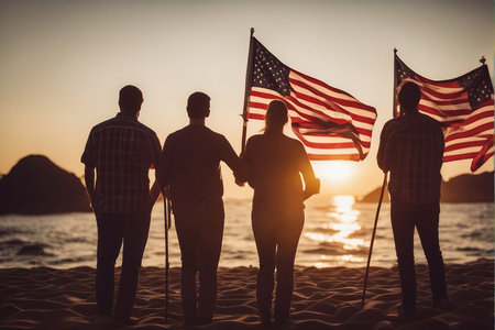 Group of people with american flag on the beach at sunset.の写真素材