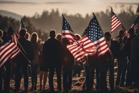 Group of people with american flag on the beach at sunset.の写真素材