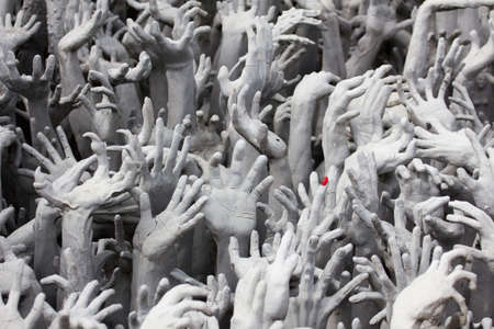 sculpture of hands of people who want to help from hellの写真素材