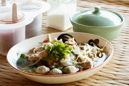 Thai noodles with seasoning on a Thai traditional matの写真素材