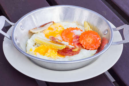 fried eggs with extra Ingredients in aluminium pan in Thai styleの写真素材