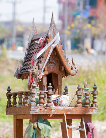 Old Thai spirit's house deserted near local streetの写真素材