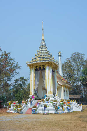 Thai style crematory with wreaths on blue sky backgroundの写真素材