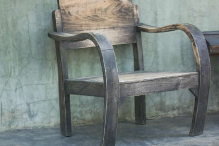 wooden chair on background of grey conceteの写真素材