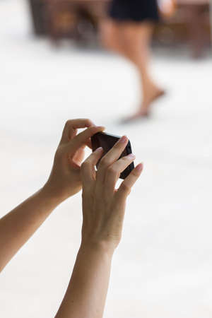 hands of female taking a picture with mobile phoneの写真素材
