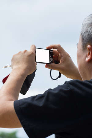 old male taking a picture with cameraの写真素材