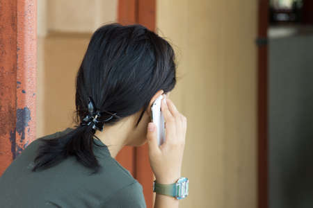 thai girl with a mobile phone, telephoningの写真素材