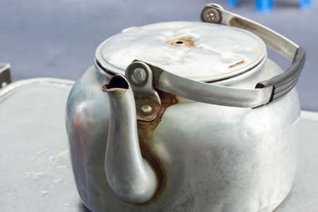 old small classic kettle  on the table in thai restaurantの写真素材