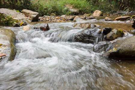 Nice small waterfall on mountain brookの写真素材