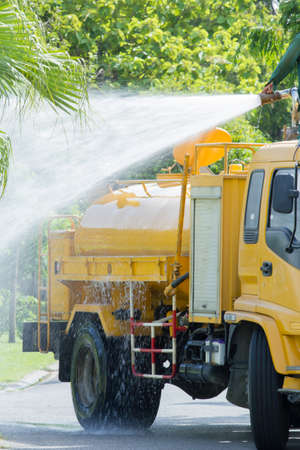 water truck watering in the garden, in thailandの写真素材