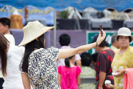 CHIANGRAI, THAILAND - AUG 12: unidentified young woman taking self portraiton August 12, 2014 in Chiangrai, Thailand.のeditorial素材