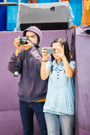 CHIANGRAI, THAILAND - AUG 12: unidentified people using camera on August 12, 2014 in Chiangrai, Thailand.のeditorial素材