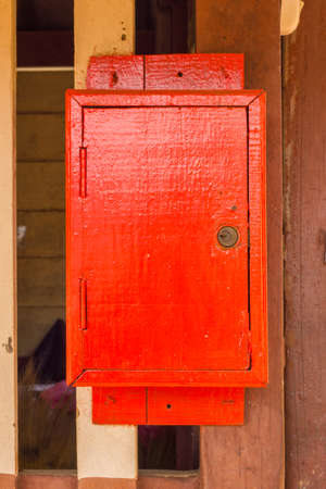 red wooden postbox on the wall.の写真素材