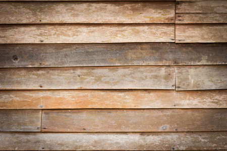 Perfectly lit wooden background with weathered wood and rusty nails