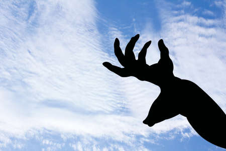 deer with horn shape hand silhouette in blue skyの写真素材