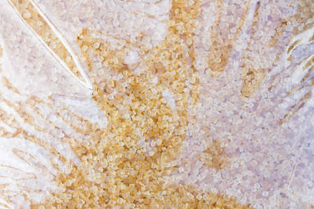 closeup of brown sugar in a plastic bag, background, with hair inside.