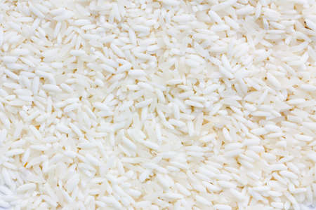 White long rice background, uncooked raw cereals, extreme macro closeupの写真素材