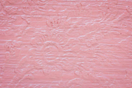 abstract in low relief on the pink wooden wall at public park in  Thailandの写真素材