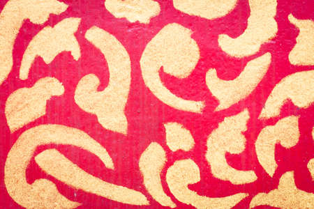thai style decor with golden pattern in red background.の写真素材