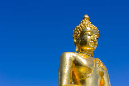 Big buddha isolated on  blue sky,Thailand, copyspace on the left.の写真素材