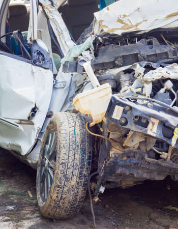Crashed car close up. The front part is severely damaged, close-upの写真素材