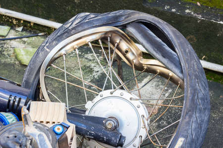 broken wheel of crashed motorcycle, accident  on the roadの写真素材