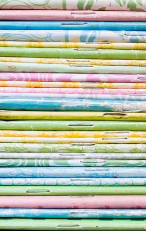 close-up of old colorful notebook spine with staples, background