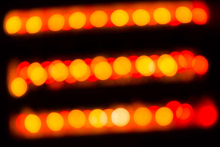 Abstract red and orange circular lines bokeh background of Christmas lightの写真素材