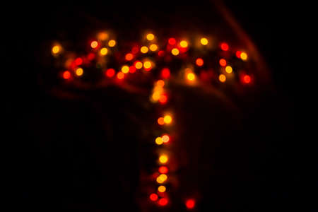 colorful letter T made of blurred circular bokeh on black backgroundの写真素材