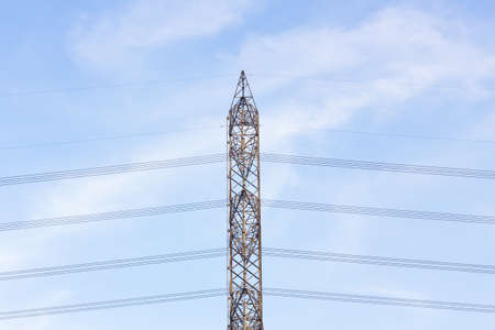 View side of high voltage poles in blue sky with cloudの写真素材