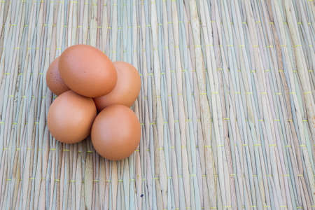 Close up of five eggs on thai traditional mat for cook, with copyspaceの写真素材