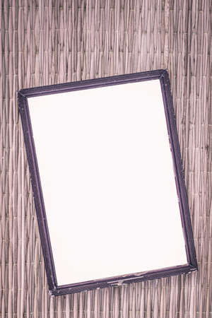wooden old black picture frame on traditional mat with white space in the middle, vintage filterの写真素材