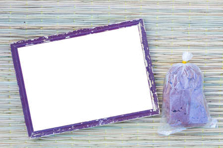 wooden old black picture frame on traditional mat with white space in the middle with shrimp paste in plastic bagの写真素材
