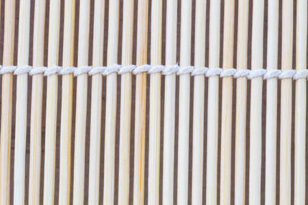 Close up macro of beige brown bamboo mat as striped background texture pattern. Oriental.の写真素材