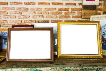 old two photo frames on the wooden tableの写真素材