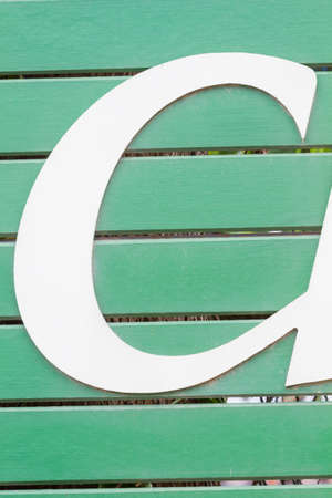 Closeup letter C on green wooden sign board in thailandの写真素材
