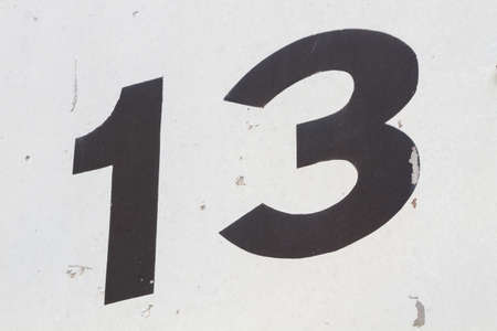 closeup black number 13 from traffic road sign in thailand background