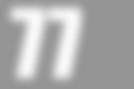 gray abstract background with defocused white international number 77 on the left, copyspace on the...