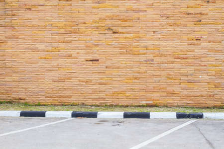 Empty parking lot with brown sandstone wall.の写真素材