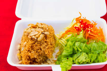 Crispy catfish salad in styrofoam box by Thailand street food vender.の写真素材