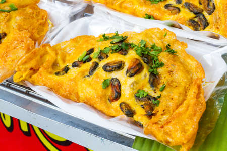 fried oyster omelette in styrofoam box by Thailand street food venderの写真素材