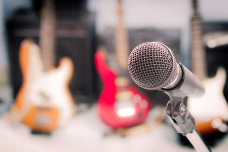 microphone with blurred musical instrument background, vintage style.の写真素材