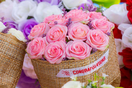 closeup bouquet of red artificial flower with word CONGRATULATIONS, success conceptの写真素材