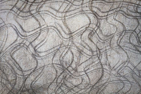 concrete wall as background with curve lines.