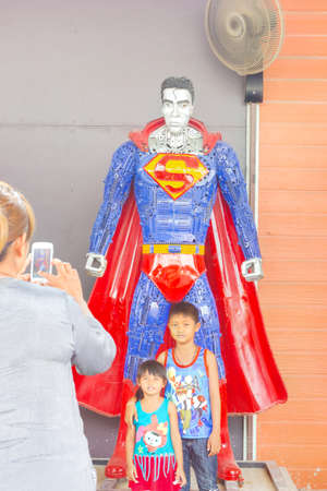 ANG THONG, THAILAND - APRIL 3 : unidentified people taking photo with Superman made of remnant of iron on April 3, 2016 in Ang Thong, Thailandのeditorial素材
