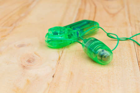 green vibrator on wooden background. Masturbation equipment for women.  Copyspace.の写真素材