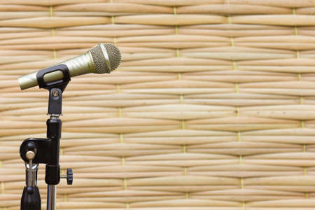 side view of microphone on blurred texture of Thai styled weave matの写真素材