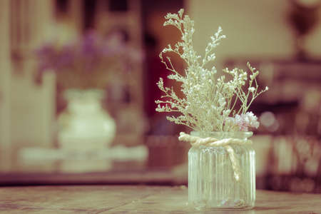 dry flowers in glass vase with rope on blurred background, copyspace. Vintage retro style.の写真素材